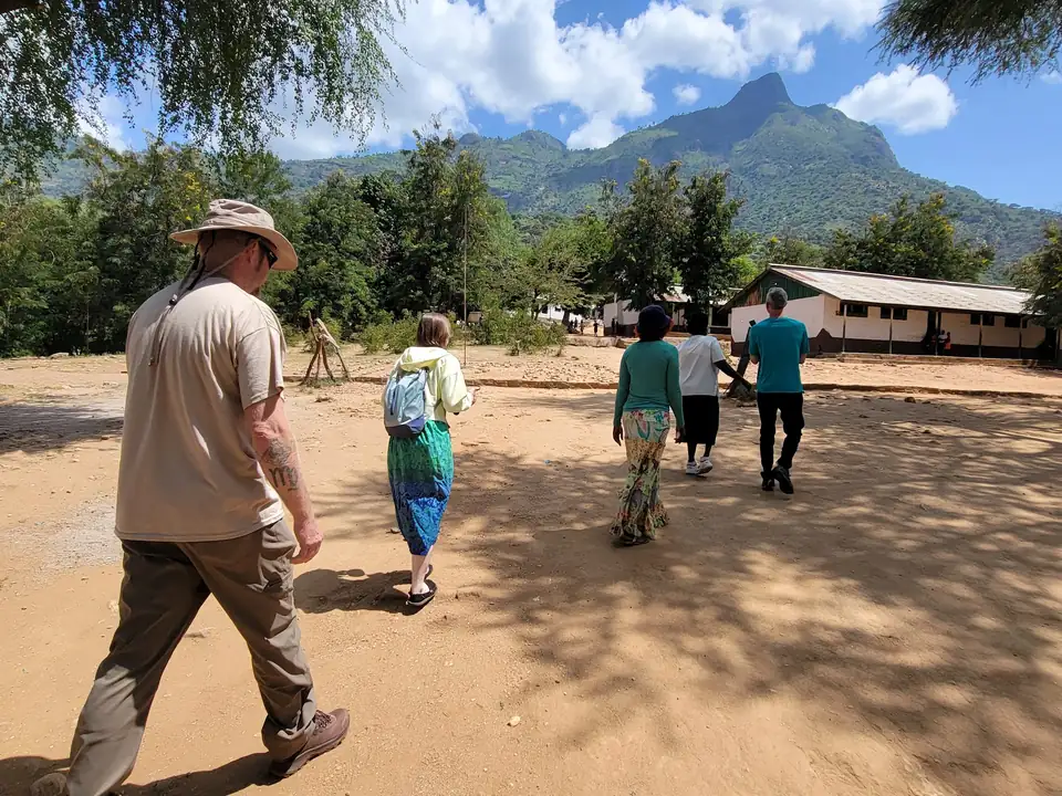 Walking across the school compound toward the mountains